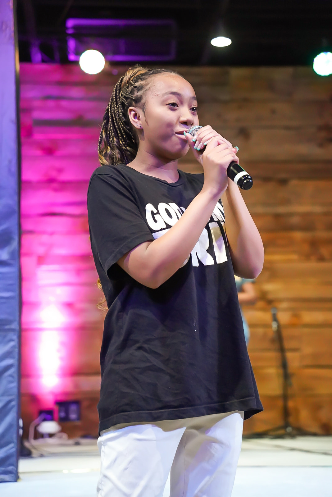 Young woman ministering with the mic