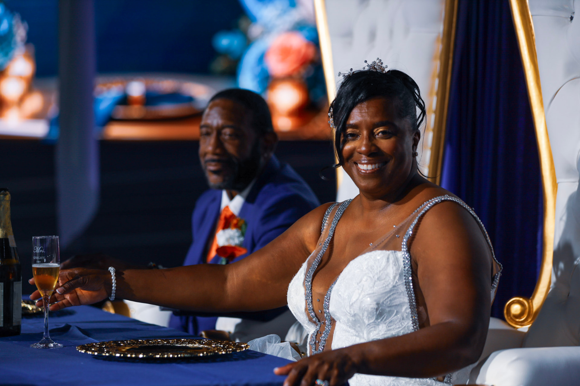 Bride smiling with a champagne flute at the reception