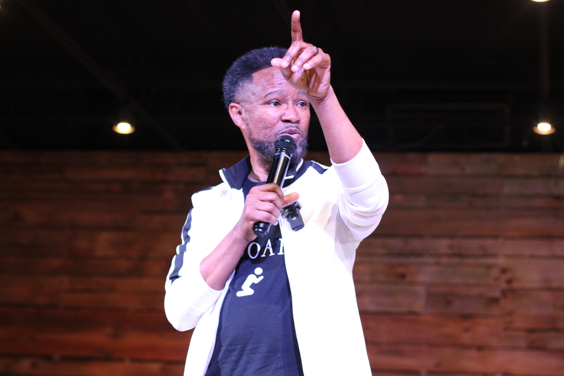 Apostle Craig preaching in a white jacket