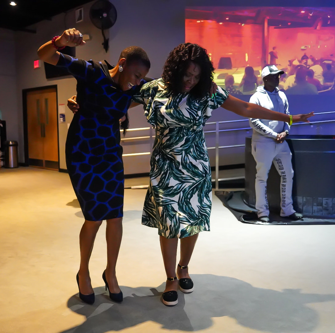Women rejoicing in the aisle