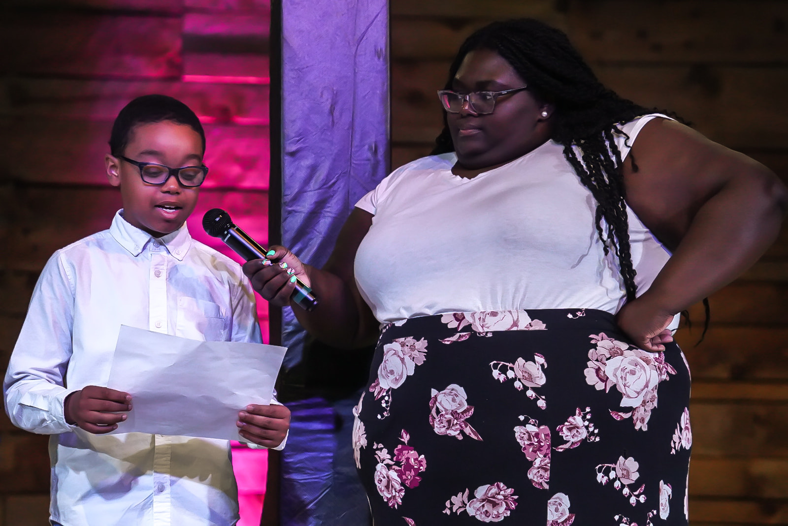 A young voice reading on stage