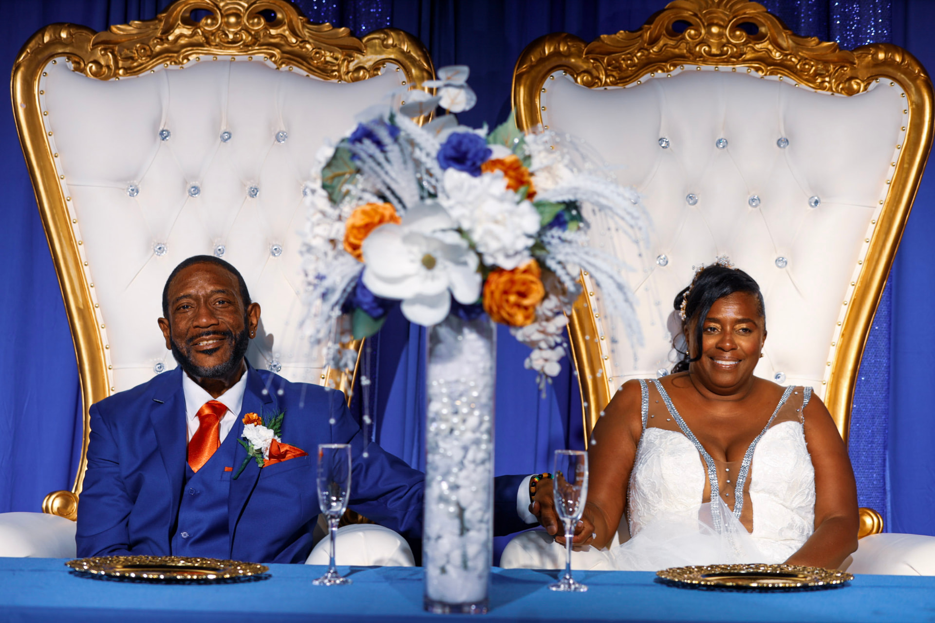 Newlyweds seated at the gold head table