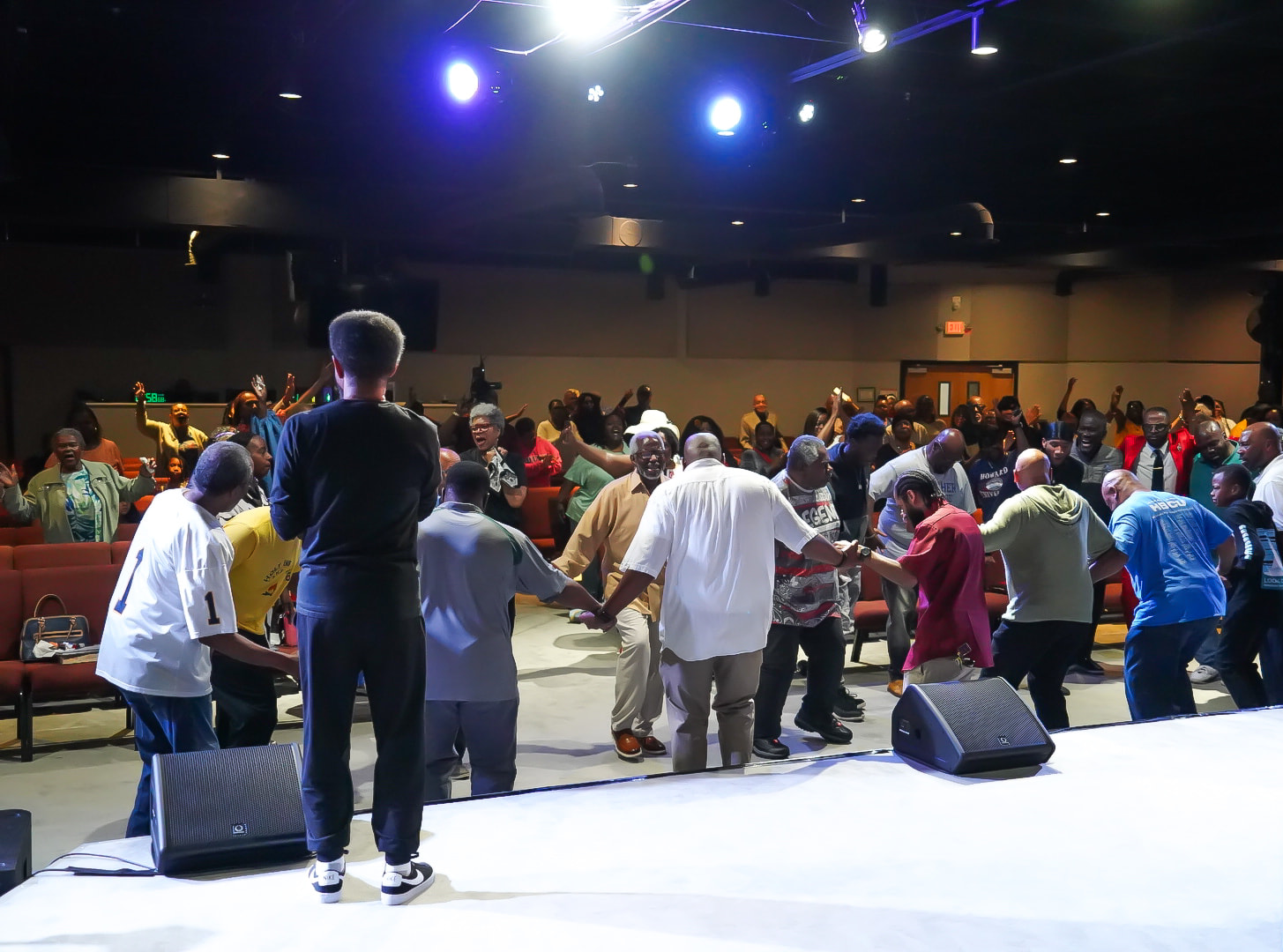 The whole room joining in prayer
