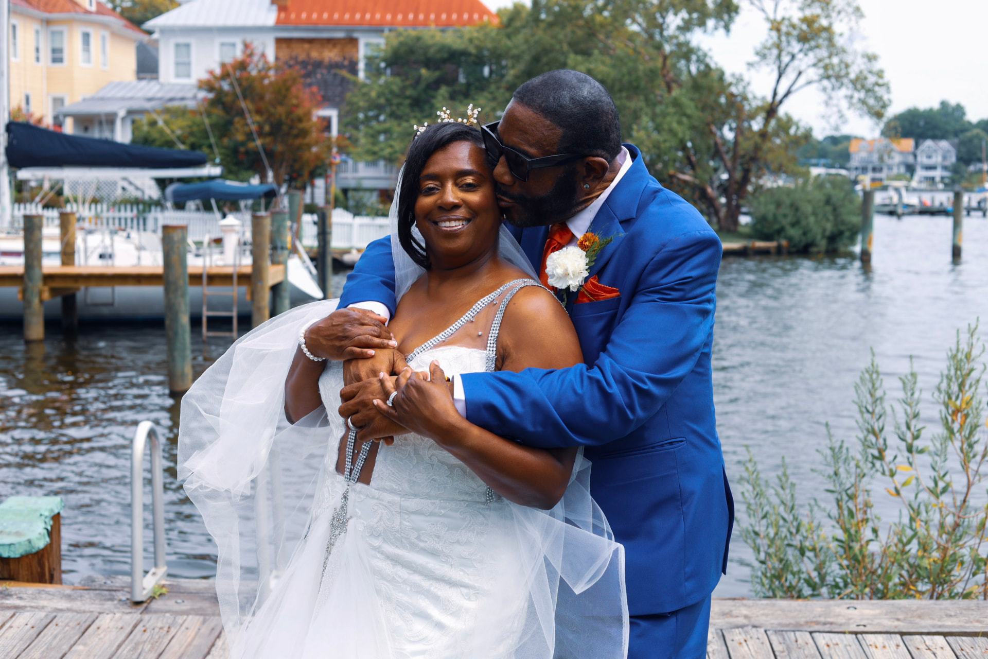 Bride and groom embracing on the waterfront