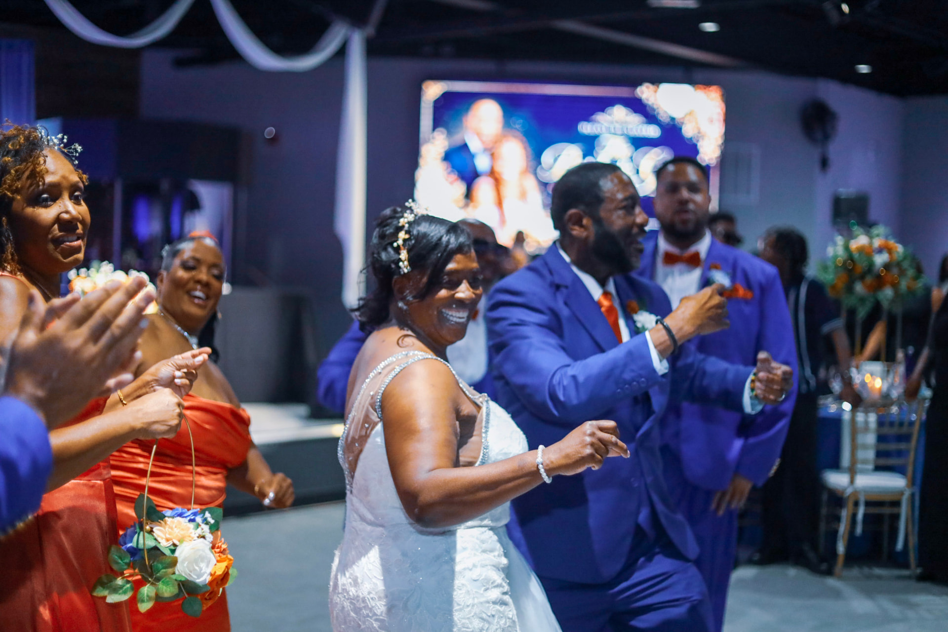 Wedding party dancing into the reception