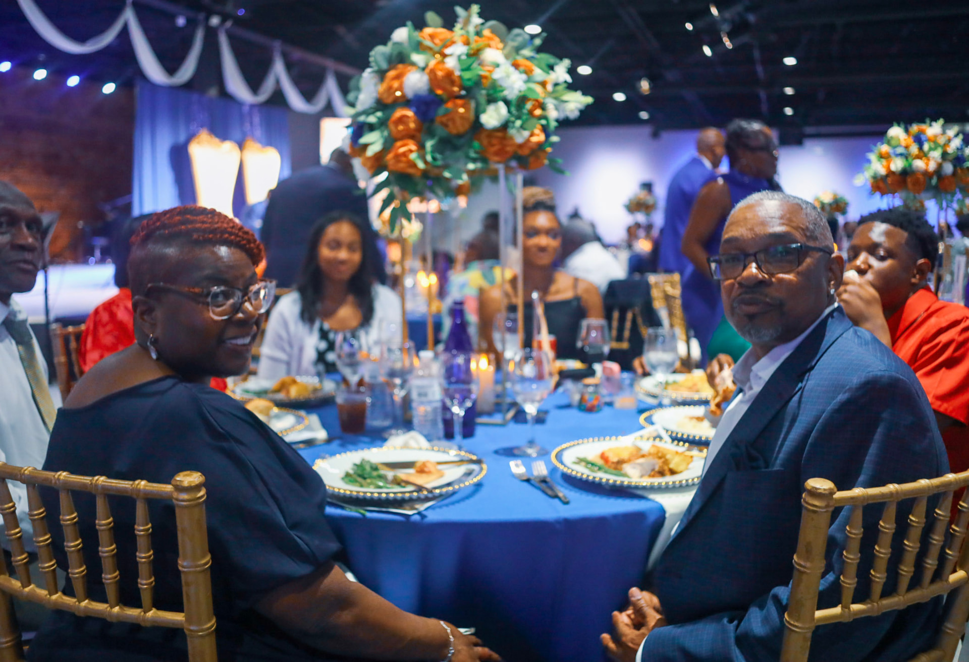 Guests seated at a decorated reception table