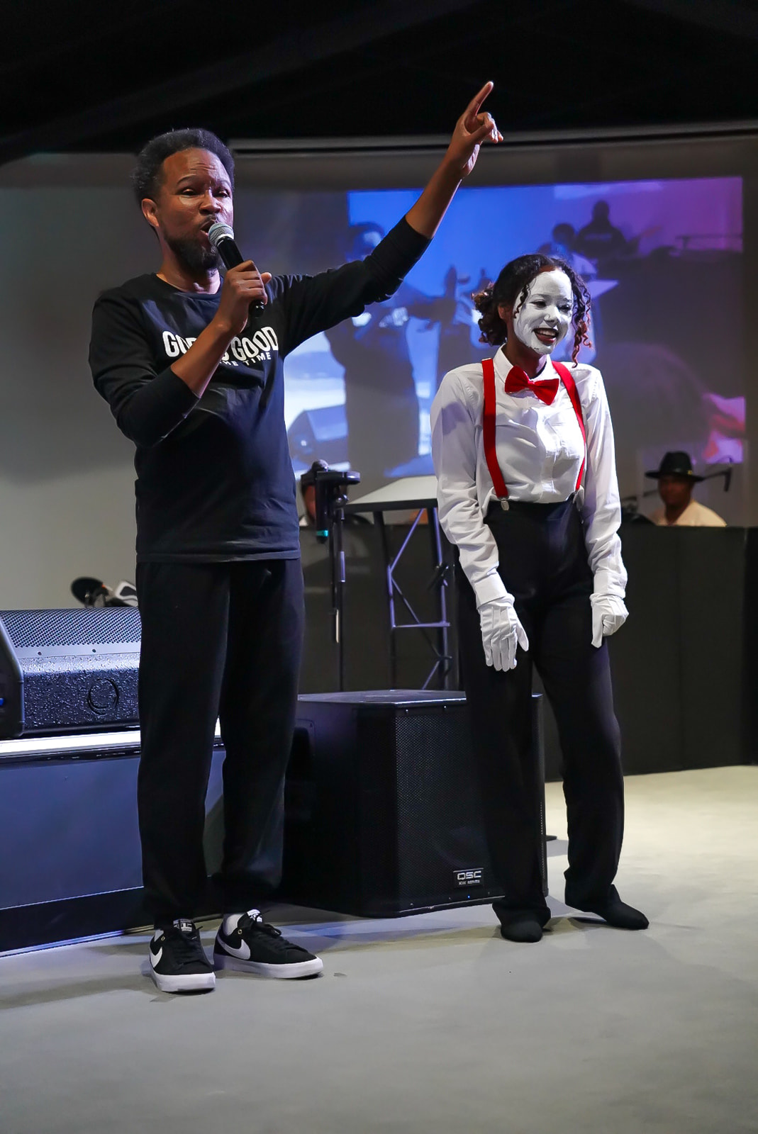 Host and mime ministering together on stage