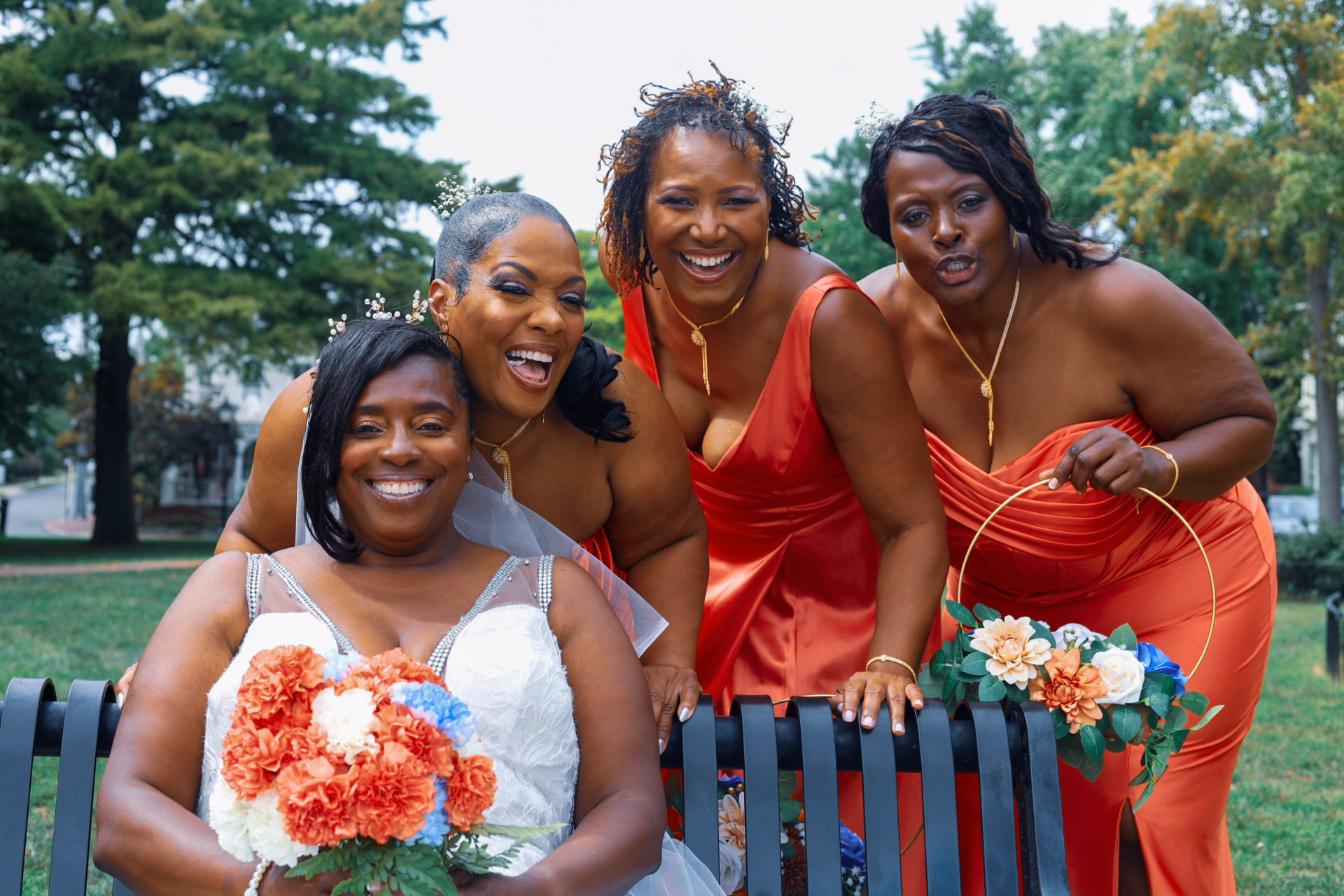 Bride laughing with her bridal party outdoors