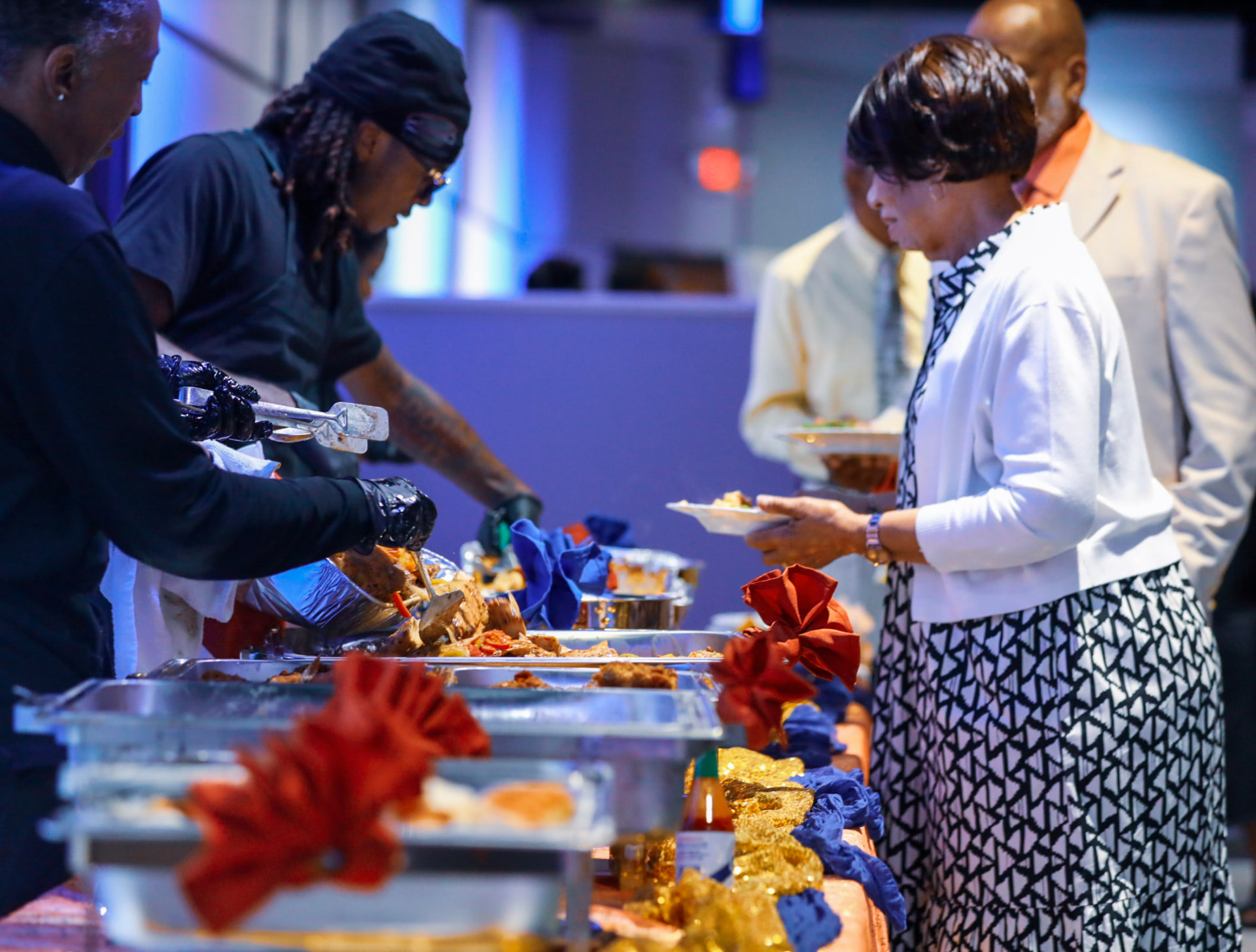 Guests being served along the catering line